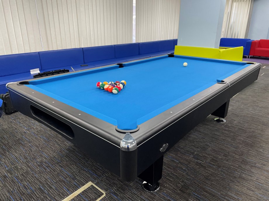 American slate bed pool table in office environment.